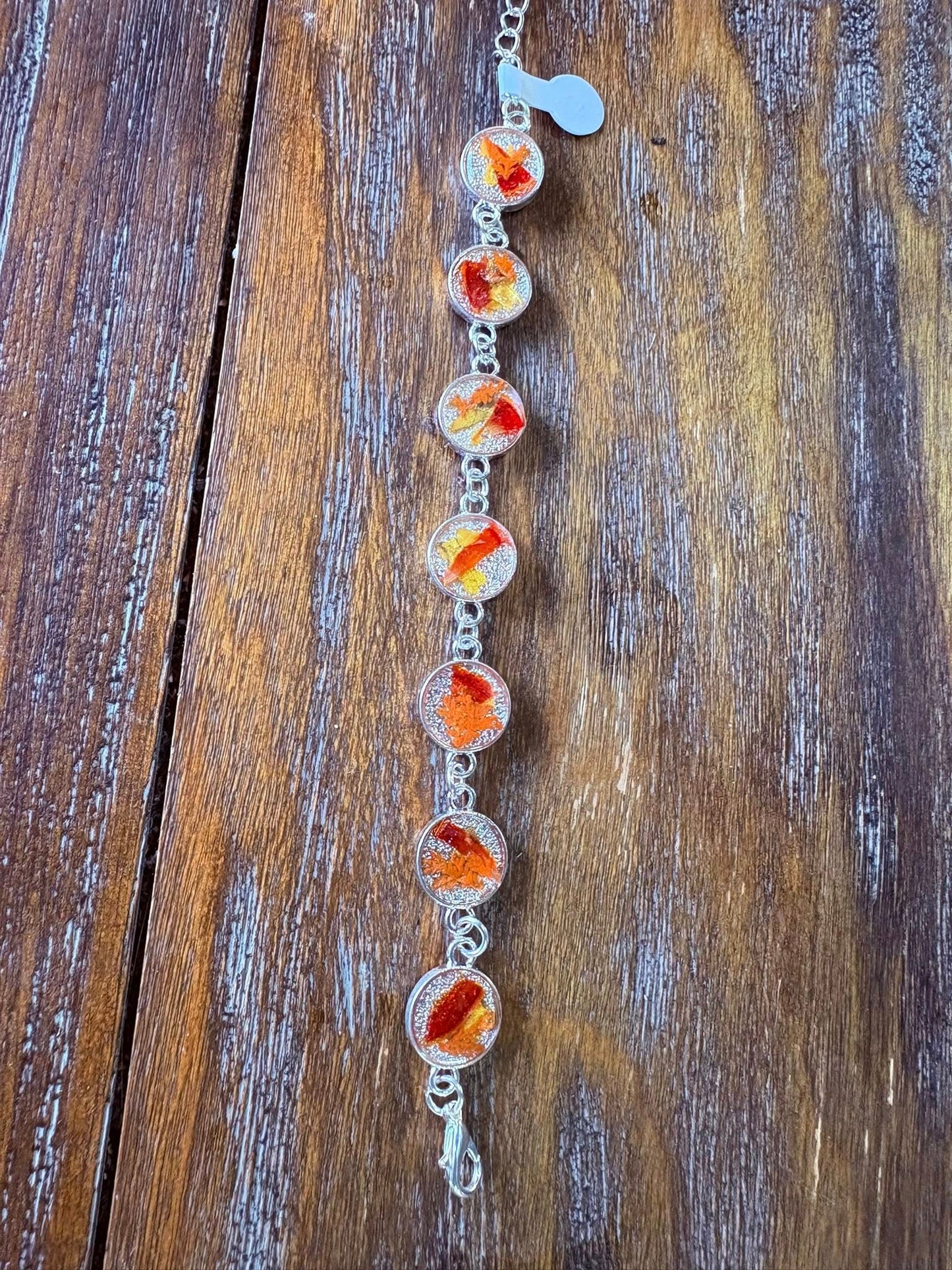 Autumn botanical bracelet with 7 baubles in silver setting (orange, red, and yellow)