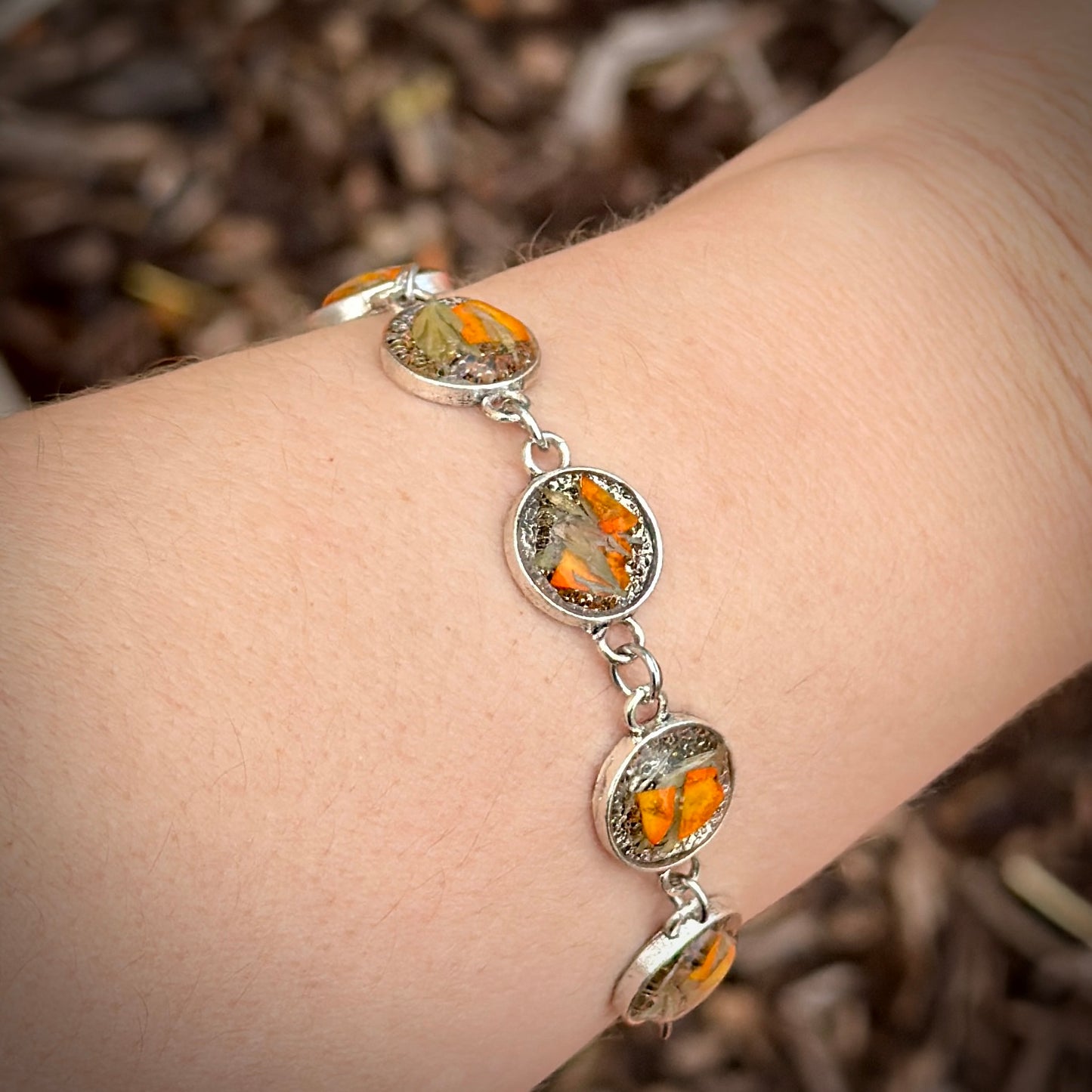 Autumn botanical bracelet with 7 baubles in silver setting (orange and green)