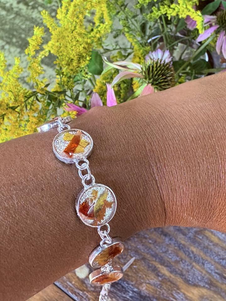 Autumn botanical bracelet with 7 baubles in silver setting (orange, red, and yellow)