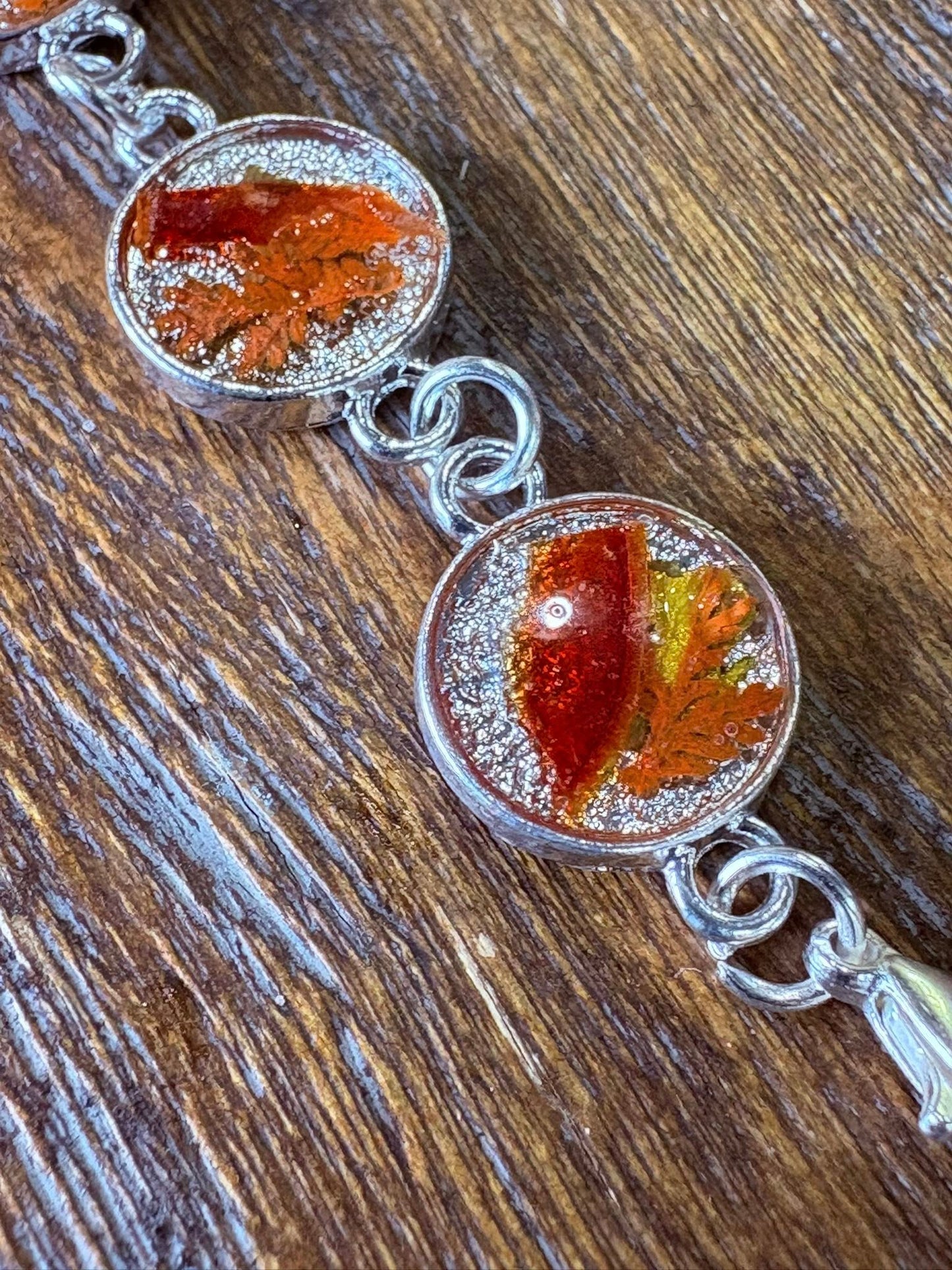 Autumn botanical bracelet with 7 baubles in silver setting (orange, red, and yellow)