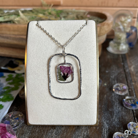Silver rectangle with dangling pink flower