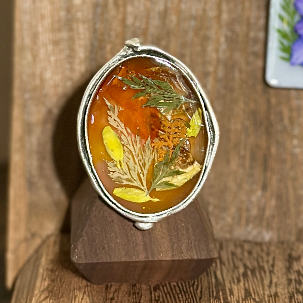 Autumn botanical ring in a large, silver oval setting