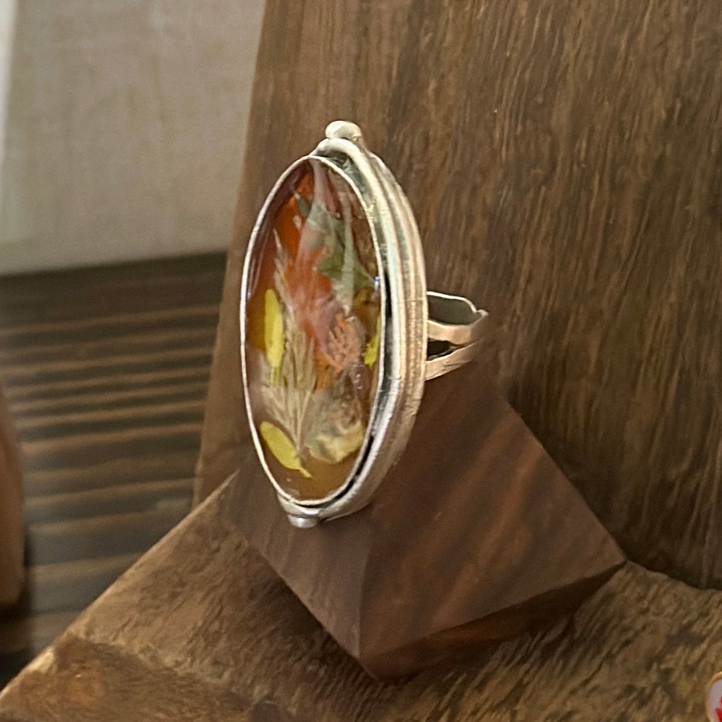 Autumn botanical ring in a large, silver oval setting