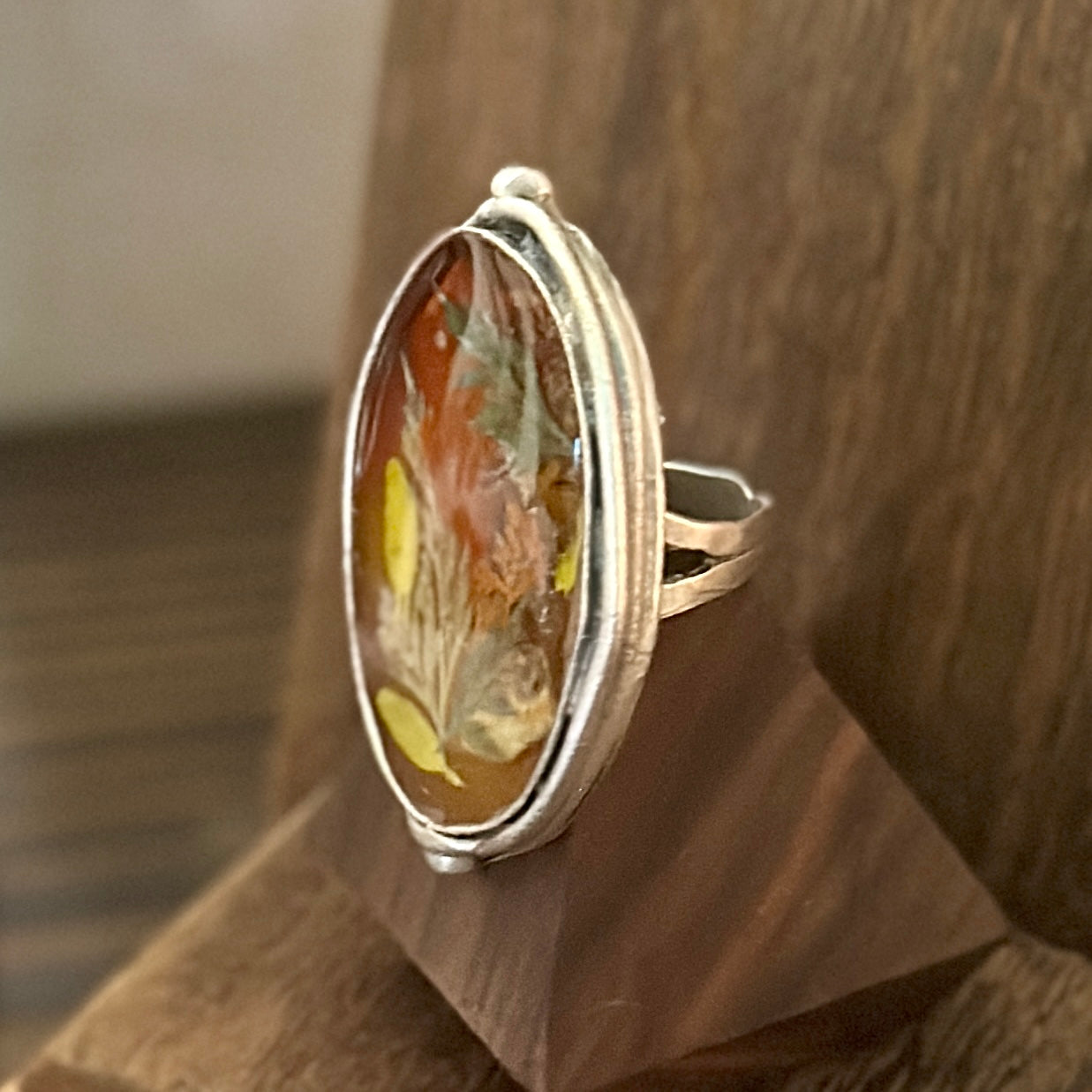 Autumn botanical ring in a large, silver oval setting
