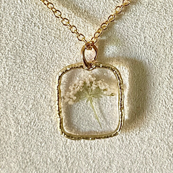 Gold-framed botanical necklace (small white flower)