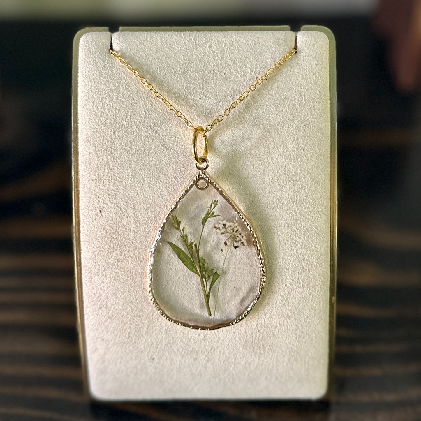 Gold-framed botanical necklace (white and green)