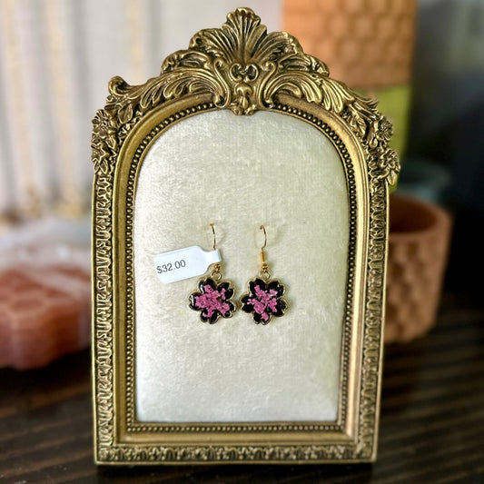 Gold-framed botanical earrings in pink and black