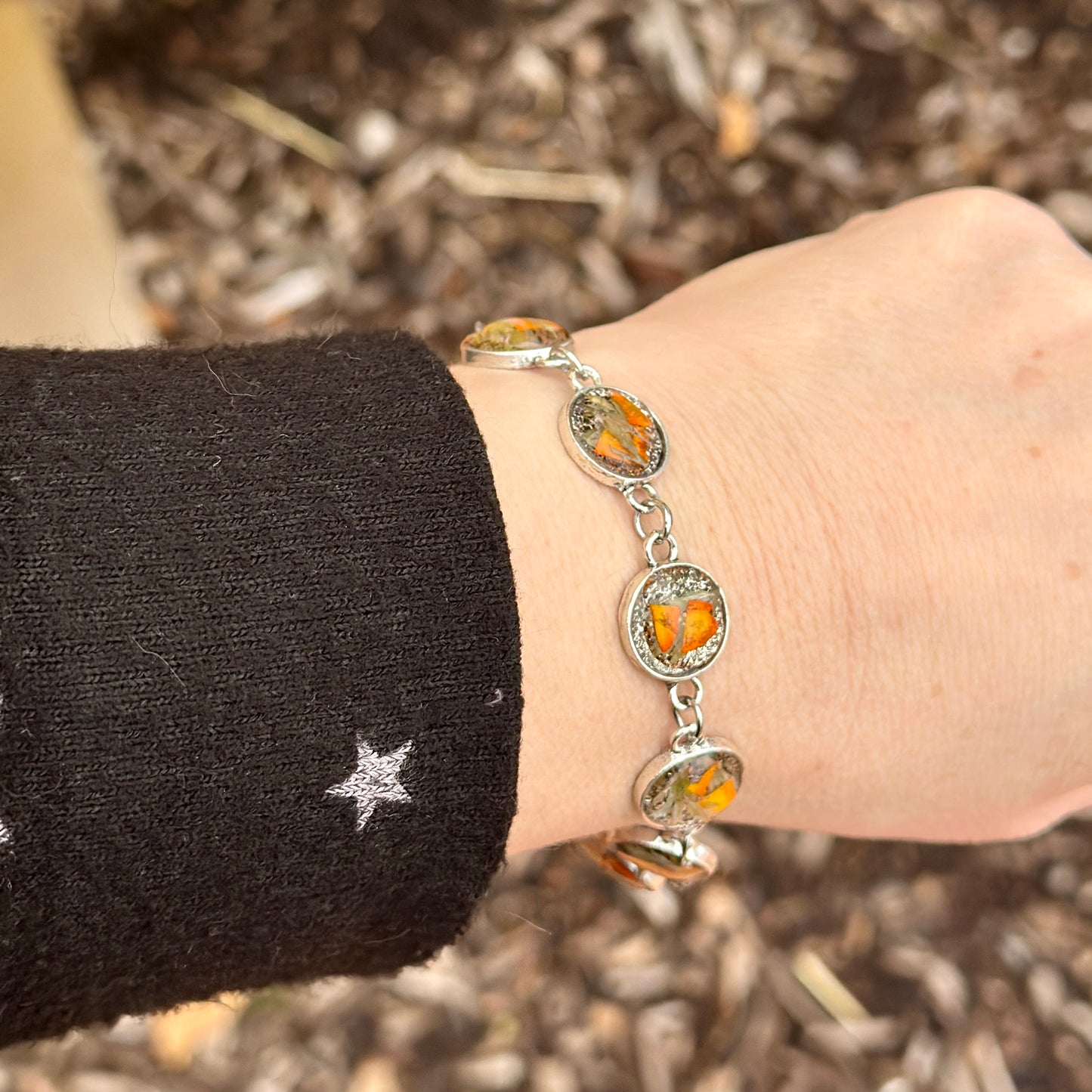Autumn botanical bracelet with 7 baubles in silver setting (orange and green)