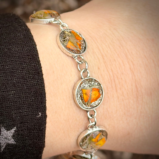 Autumn botanical bracelet with 7 baubles in silver setting (orange and green)